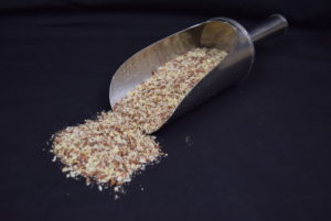 a scoop with organic macadamia nut bird supplement